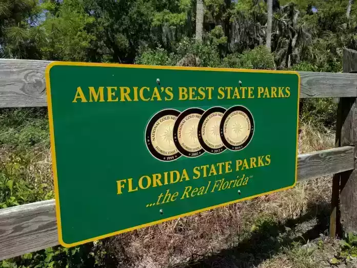 Florida state parks sign in front of a wooden fence